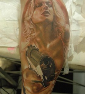 Woman and gun photorealistic tattoo