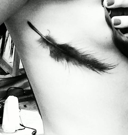 black feather tattoo faded