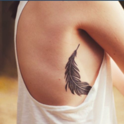 black feather tattoo upper body