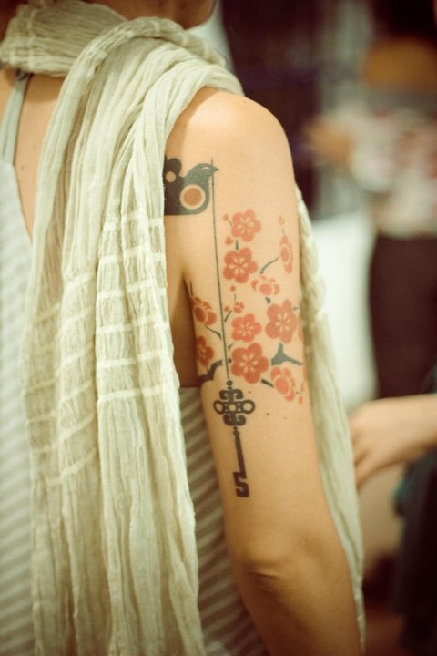 red tattoo bird key flowers