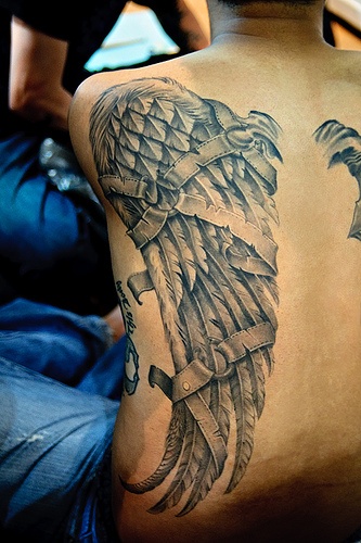 Amazing broken wing tattoo