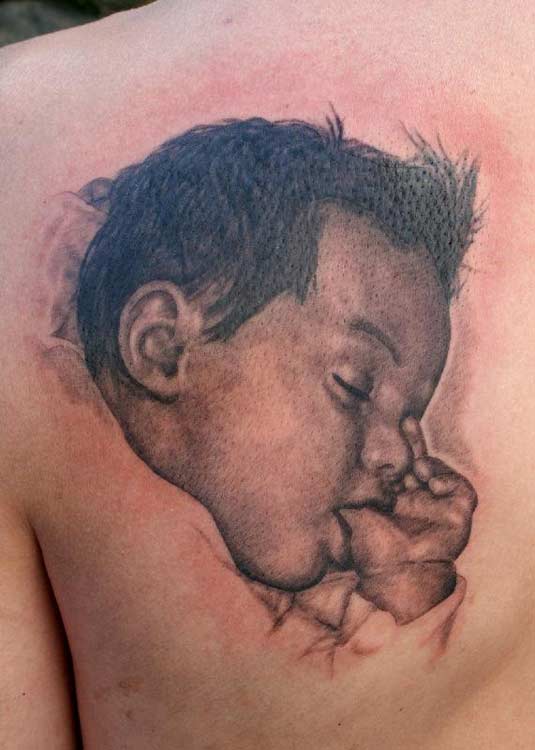 Awesome tattoo with sleeping baby