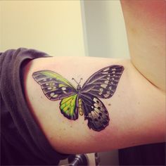 Black & green butterfly on muscle