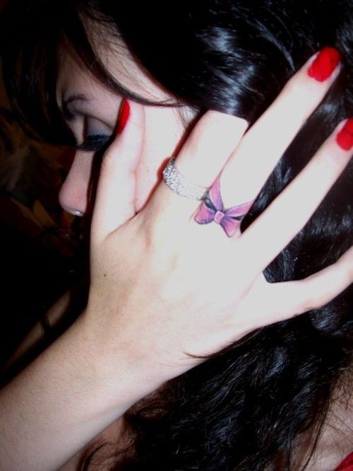 Bow finger tattoo