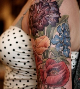 Colorful flowers tattoo by Alice Carrier