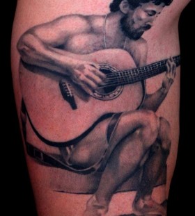 Man and guitar tattoo by Art Junkies