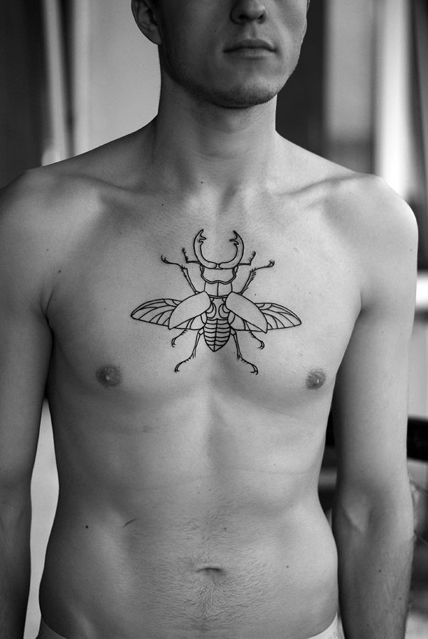 Men chest bug tattoo