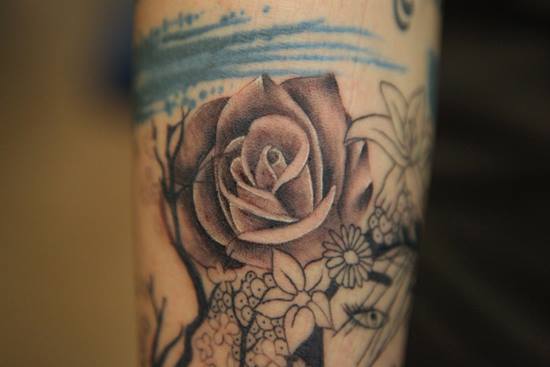 Rose tattoo by Nikki Ouimette