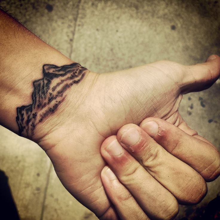 Simple hand mountains tattoo