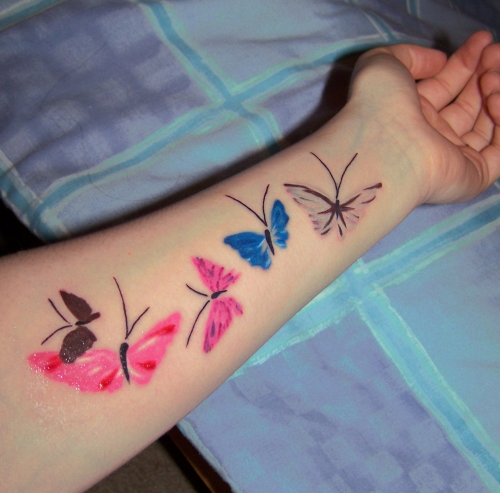 colored butterly on the arm