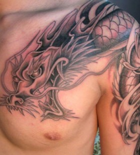 Arm and shoulder dragon tattoo