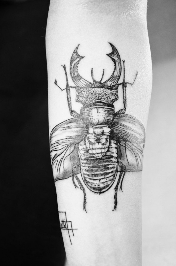 Black insect tattoo