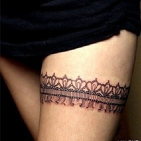 Crown on leg lace tattoo