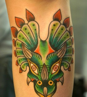 Green dinosaur tattoo