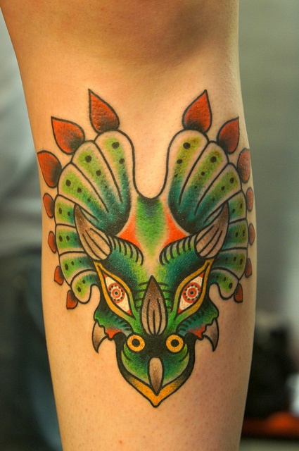 Green dinosaur tattoo