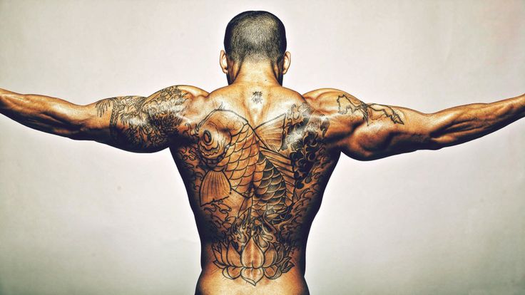 Men’s back fish and infinity tattoo