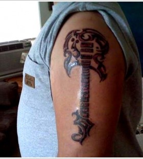 Men's shoulder guitar tattoo