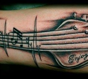 Quote and guitar tattoo
