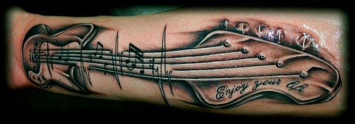 Quote and guitar tattoo