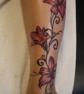 Red flowers legs tattoo