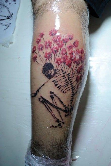 Skull and flowers tattoo by Tyago Compiani