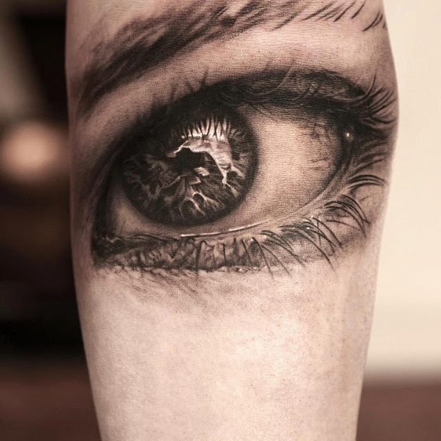 3D black eye tattoo on arm