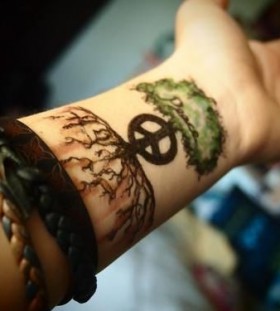 Adorable black and green tree tattoo on arm