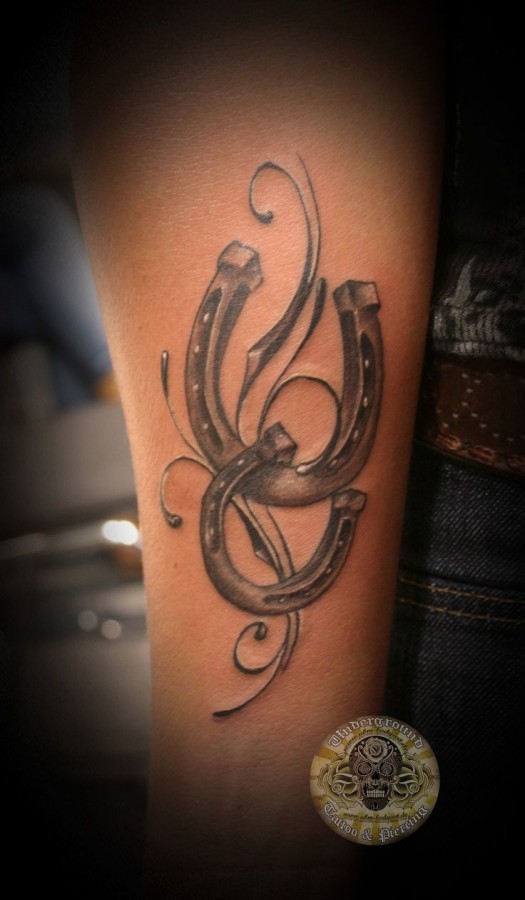 Adorable black horse shoe tattoo