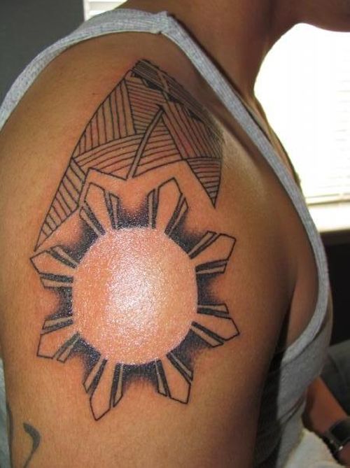 Adorable black sun tattoo on shoulder