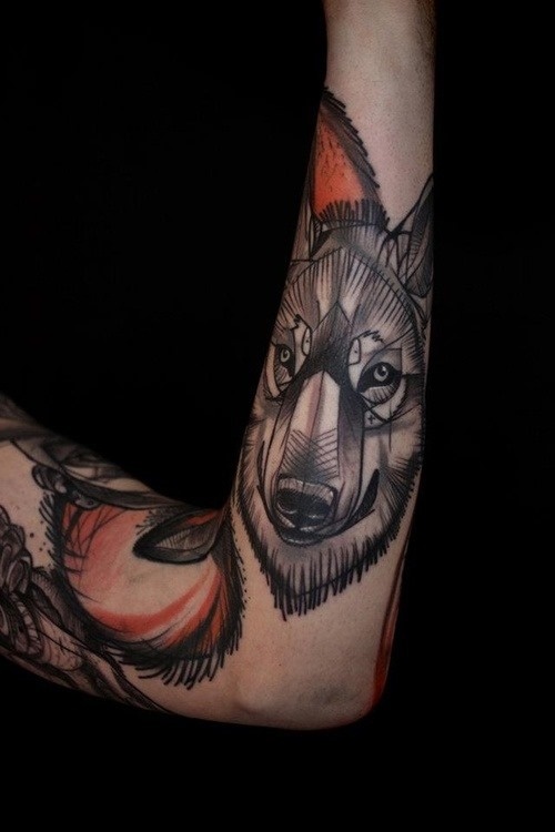 Adorable black wolf tattoo on arm