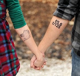 Adorable couple camera tattoo on arm