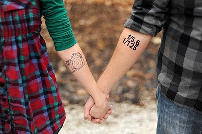 Adorable couple camera tattoo on arm