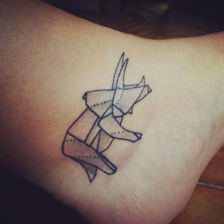 Adorable dinosaur origami tattoo on leg