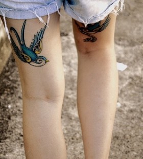 Adorable girl blue birds tattoos on leg