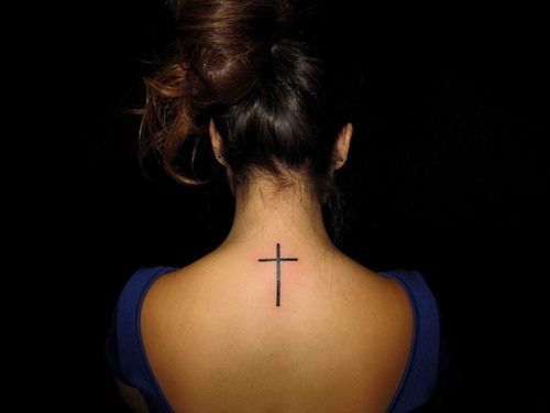 Adorable girl’s back cross tattoo