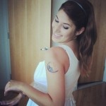 Adorable girl's moon tattoo on shoulder