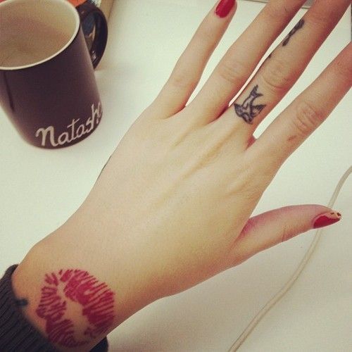 Adorable nails and lips tattoo on arm