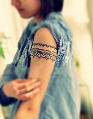 Adorable women lace tattoo on arm