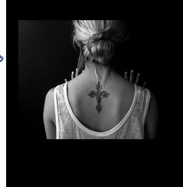 Amazing girl’s back cross tattoo