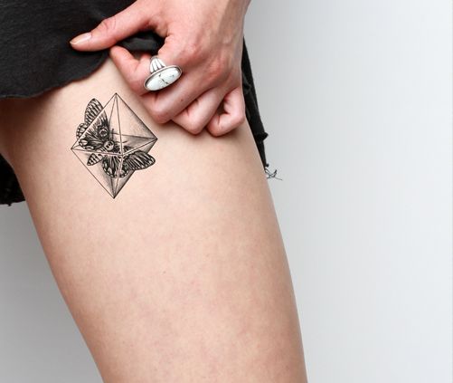 Amazing insect crystal tattoo on leg