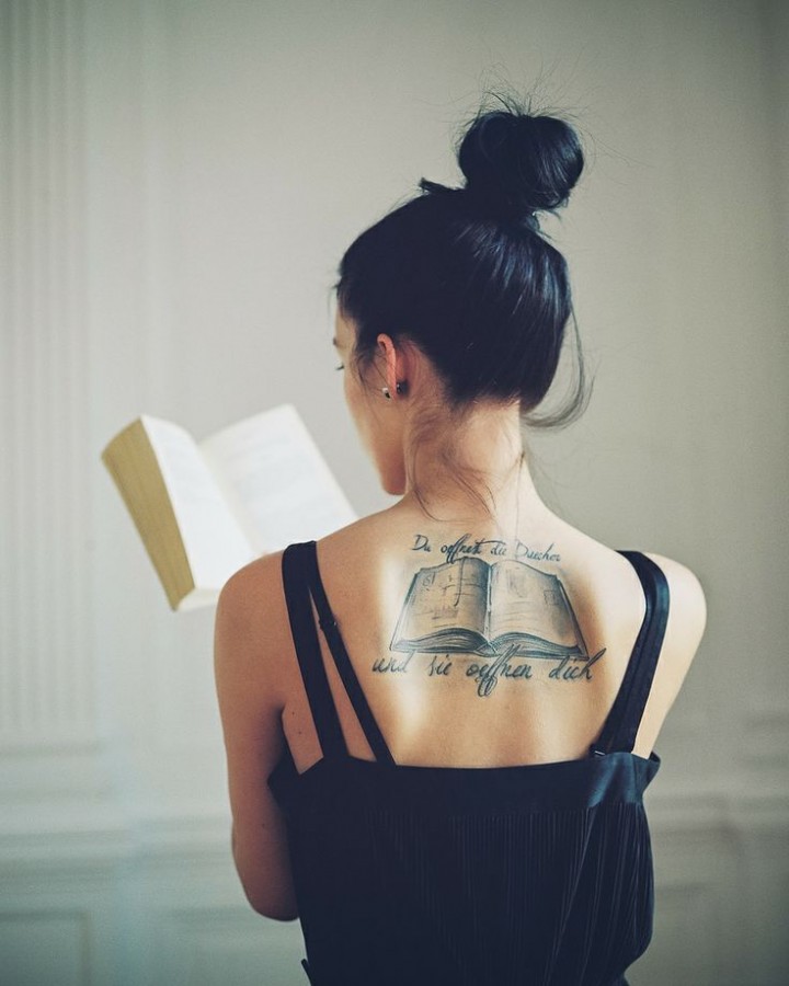 Amazing women’s back book tattoo