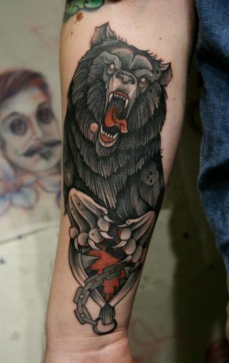 Angry black bear tattoo on arm