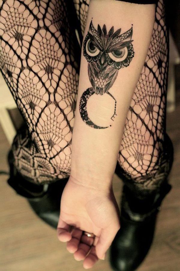 Angry black owl and moon tattoo on arm