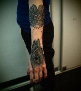 Angry owl and wolf tattoo on arm