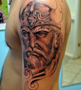 Angry vikings face tattoo on arm