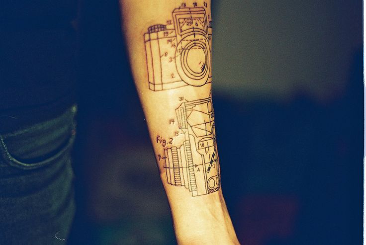 Awesome black camera tattoo on arm