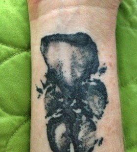 Awesome black pawprints dog tattoo on arm