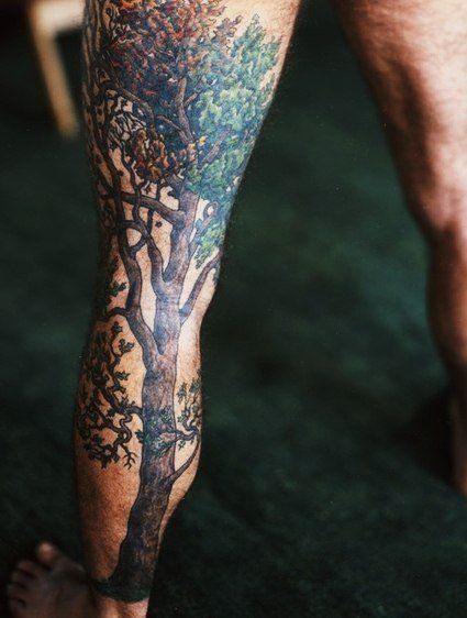 Awesome black tree tattoo on leg