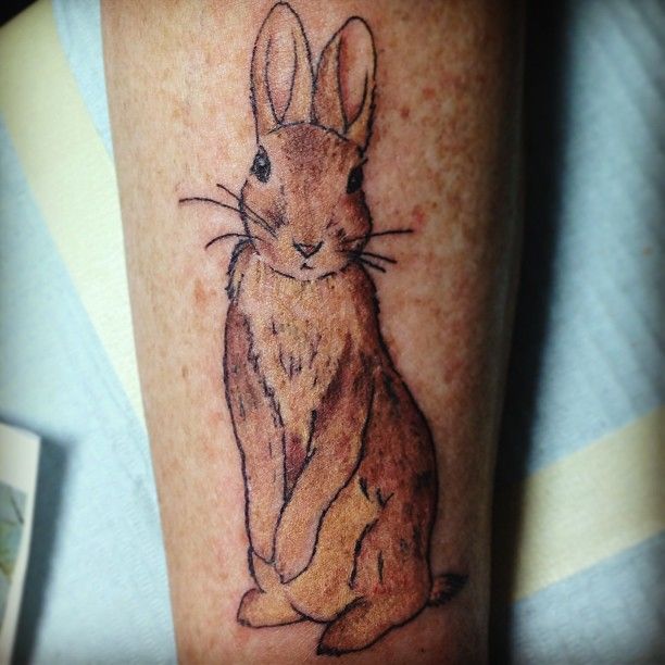 Beautiful brown rabbit tattoo on arm