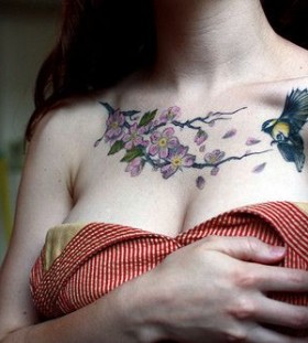 Bird and purple flower tattoo on chest